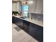 Modern kitchen with dark cabinets, white countertops, and stylish backsplash at 312 Douglas Park Ave, Davenport, FL 33897