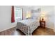 Bright bedroom featuring a leafy patterned bedspread and wood floors at 3754 Wildcat Run, Lakeland, FL 33810