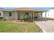 Tan house with covered porch and landscaping at 3754 Wildcat Run, Lakeland, FL 33810