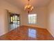 Bright dining room featuring elegant chandelier and wood-look tile floor at 4152 Aberdeen Ln, Lake Wales, FL 33859