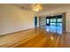 Spacious bedroom with hardwood floors, ceiling fan, and large window at 4152 Aberdeen Ln, Lake Wales, FL 33859