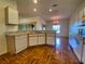 Kitchen with dishwasher, white cabinets, and view of dining area at 4152 Aberdeen Ln, Lake Wales, FL 33859