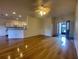 Bright living room with hardwood floors, ceiling fan, and access to the kitchen at 4152 Aberdeen Ln, Lake Wales, FL 33859