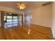 Spacious living room with hardwood floors and sliding glass doors to lanai at 4152 Aberdeen Ln, Lake Wales, FL 33859