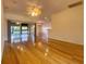Open living area with hardwood floors and access to kitchen and lanai at 4152 Aberdeen Ln, Lake Wales, FL 33859