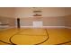 Indoor basketball court with polished wood flooring and a regulation hoop at 4152 Aberdeen Ln, Lake Wales, FL 33859