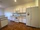 Kitchen features white cabinets, microwave, stove and refrigerator at 4152 Aberdeen Ln, Lake Wales, FL 33859