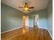 Bright bedroom with hardwood floors and ceiling fan at 4152 Aberdeen Ln, Lake Wales, FL 33859