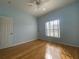 Light blue bedroom with hardwood floors and ceiling fan at 4152 Aberdeen Ln, Lake Wales, FL 33859
