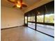 Sunroom with tiled floor, ceiling fan and pond view at 4152 Aberdeen Ln, Lake Wales, FL 33859