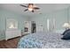 Main bedroom with white dresser, and floral bedding, and wood floors at 4536 Turnberry Ln, Lake Wales, FL 33859