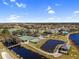 Aerial view of community with tennis courts, clubhouse, and lake at 4536 Turnberry Ln, Lake Wales, FL 33859