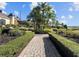 Brick pathway meanders through lush landscaping, leading to a clubhouse at 4536 Turnberry Ln, Lake Wales, FL 33859