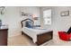 Cozy bedroom with a twin bed and a red accent chair at 535 Noble Ave, Davenport, FL 33837