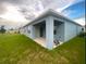 View of the home's back, highlighting the covered patio at 535 Noble Ave, Davenport, FL 33837