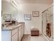 Elegant bathroom featuring double vanity and a large shower at 535 Noble Ave, Davenport, FL 33837