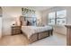 Bright bedroom with a queen-size bed and wood nightstands at 535 Noble Ave, Davenport, FL 33837