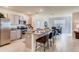 Open concept kitchen with island, granite countertops, and gray cabinets at 535 Noble Ave, Davenport, FL 33837