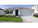 Single-story home with a two-car garage and well-maintained landscaping at 535 Noble Ave, Davenport, FL 33837