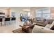 Open-concept kitchen with island, stainless steel appliances, and gray cabinets at 535 Noble Ave, Davenport, FL 33837