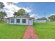 Single story home with red brick walkway and green lawn at 738 Strain Blvd, Lakeland, FL 33815