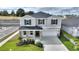 Two-story house with gray siding, stone accents, and a two-car garage at 9660 Westside Hills Dr, Davenport, FL 33896