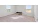 Bright bedroom with neutral carpeting and two large windows at 9660 Westside Hills Dr, Davenport, FL 33896