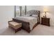 Elegant bedroom with plush upholstered bed and wooden nightstand at 9660 Westside Hills Dr, Davenport, FL 33896