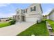 Two-story house with gray siding, stone accents, and a two-car garage at 9660 Westside Hills Dr, Davenport, FL 33896