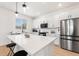 Modern kitchen with stainless steel appliances and white cabinetry at 9660 Westside Hills Dr, Davenport, FL 33896