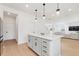 Kitchen island with white cabinets and quartz countertop at 9660 Westside Hills Dr, Davenport, FL 33896