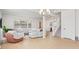 Open living room, stairs, and view into kitchen at 9660 Westside Hills Dr, Davenport, FL 33896