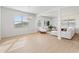 Open living room with light wood floors and sectional sofa at 9660 Westside Hills Dr, Davenport, FL 33896