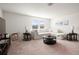 Bright living room featuring a comfortable sectional sofa and large TV at 9660 Westside Hills Dr, Davenport, FL 33896