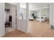 Open living room with hardwood floors, and a view of a bathroom at 9660 Westside Hills Dr, Davenport, FL 33896