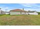 Large backyard with grassy area and a partial view of the house at 1028 Dampierre Ct, Kissimmee, FL 34759