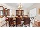 Formal dining room with wood table and chairs, and a large window at 1028 Dampierre Ct, Kissimmee, FL 34759