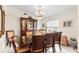 Formal dining room with wood table and chairs, and a large window at 1028 Dampierre Ct, Kissimmee, FL 34759