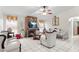 Living room with white furniture, fireplace, and a ceiling fan at 1028 Dampierre Ct, Kissimmee, FL 34759