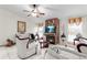 Living room features a fireplace, white furniture, and a ceiling fan at 1028 Dampierre Ct, Kissimmee, FL 34759