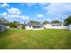 Large backyard with grassy area, shed, and screened porch at 105 Elliott Ln, Winter Haven, FL 33884