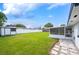 View of backyard with shed, screened porch, and grassy area at 105 Elliott Ln, Winter Haven, FL 33884