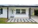 Front entrance with a stone walkway and modern door at 105 Elliott Ln, Winter Haven, FL 33884