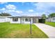 Updated single-story home with solar panels, carport, and well-manicured lawn at 105 Elliott Ln, Winter Haven, FL 33884