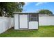 White storage shed with black trim in backyard at 105 Elliott Ln, Winter Haven, FL 33884