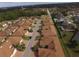 Community view showing numerous villas and a tranquil lake at 1644 Linz Ct, Winter Haven, FL 33884