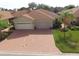 Aerial view of two-car garage home with brick driveway at 1644 Linz Ct, Winter Haven, FL 33884