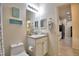 Bathroom with toilet, vanity, and access to kitchen at 1644 Linz Ct, Winter Haven, FL 33884