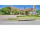 Exterior view of community clubhouse with attractive landscaping and brick driveway at 1644 Linz Ct, Winter Haven, FL 33884