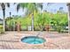 Clean and relaxing community spa with brick patio and lush landscaping at 1644 Linz Ct, Winter Haven, FL 33884